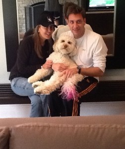 Stacy and Mike Greenberg with their dog, Phoebe, who sports a pink tail in honor of breast cancer awareness.