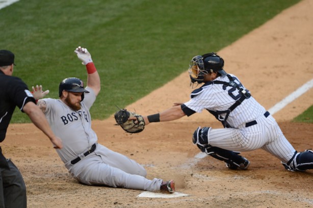 (L-R) Boston's Jonny Gomes tried to avoid the tag of New York's Francisco Cervelli in a game earlier this season. (Allen Kee / ESPN Images)