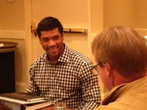 Former "Gruden QB Camp" participant Russell Wilson talks with Jon Gruden in advance of tonight's Seattle-St. Louis game MNF game. (Photo by Jim Carr)