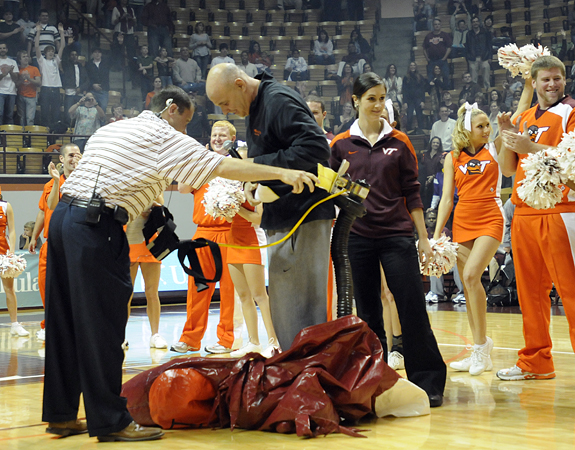 Caption: In 2009 when he was coaching at Virginia Tech, current ESPN analyst Seth Greenberg (black shirt) surprised a Midnight Madness crowd by performing in an inflatable "Hokie Bird" suit. (Photo courtesy VT Athletics)