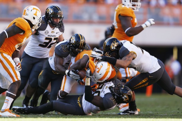 GETTY CAPTION:  Kenronte Walker #30, Zaviar Gooden #25 and Shane Ray #56 of the Missouri Tigers make a tackle against the Tennessee Volunteers during the game at Neyland Stadium on November 10, 2012 in Knoxville, Tennessee. Missouri won 51-48 in four overtimes. (Photo credit: Joe Robbins/Getty Images)