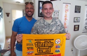 Sunday NFL Countdown feature reporter Jim Trotter (left) interviewed U.S. Army Specialist Tom McAllister, who shows the Steelers “Terrible Towel” signed by Antonio Brown. (Tory Zawacki/ESPN)  